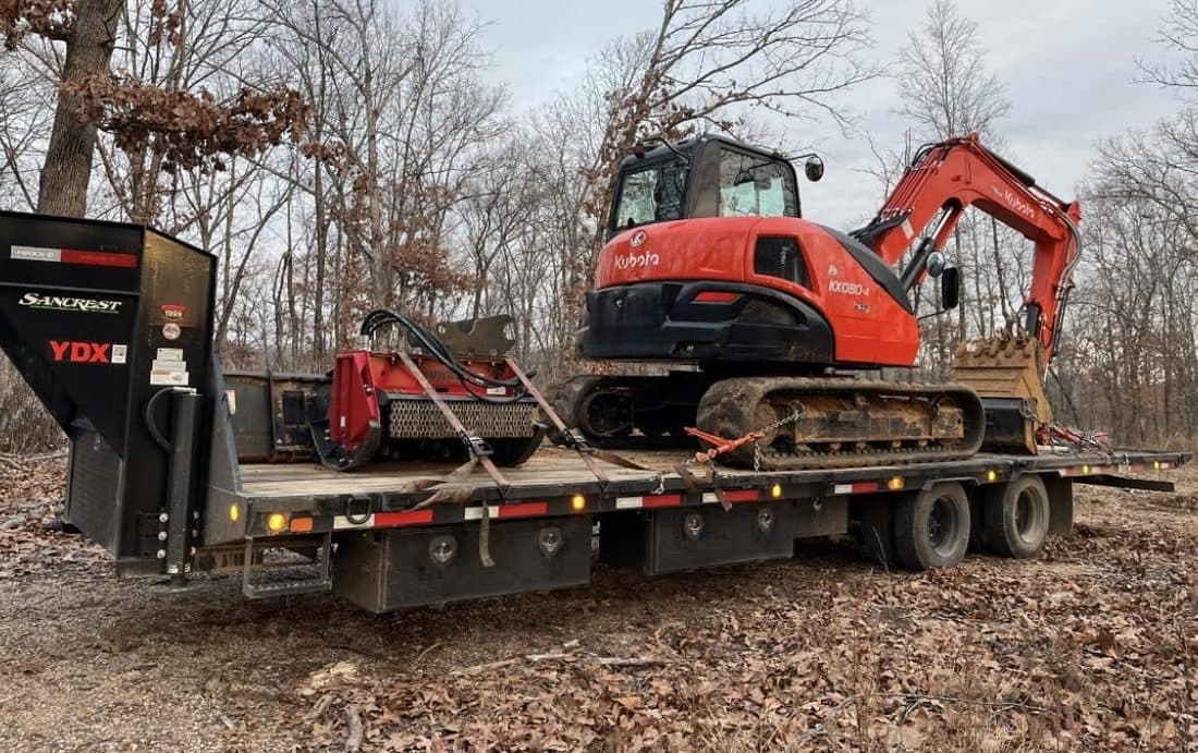 Excavator loaded on a lowboy trailer for transport
